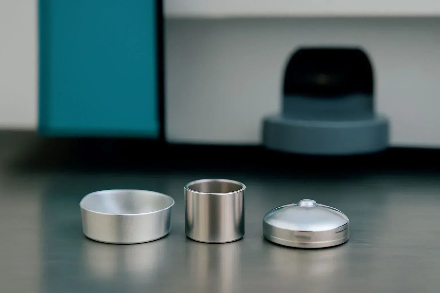 Assortment of PerkinElmer DSC sample pans illustrating critical technical specifications like material, volume, and flatness that influence thermal analysis accuracy.