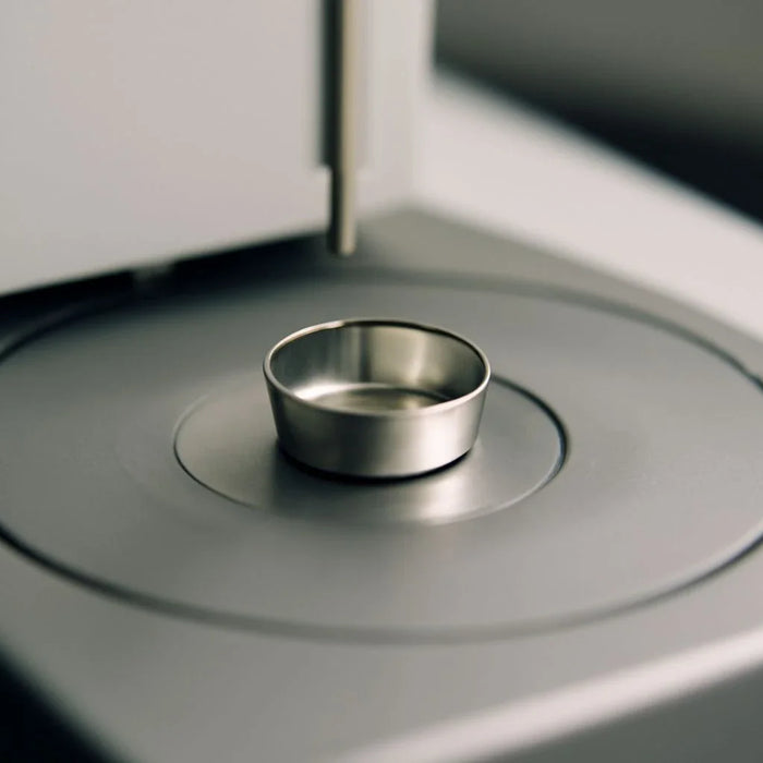 Crucible used in simultaneous DSC-TGA testing setup for accurate thermal analysis.