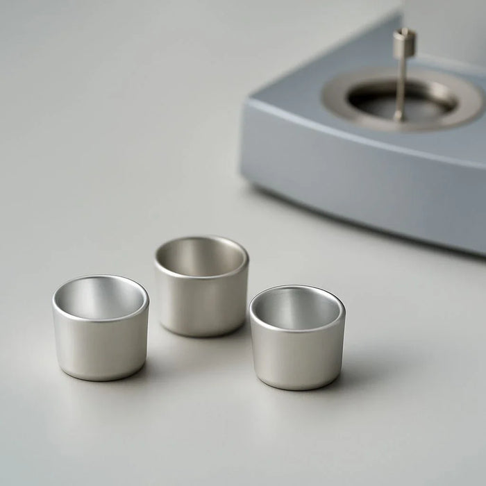 Custom thermal analysis crucibles with precise specifications for high-temperature testing and chemical resistance.
