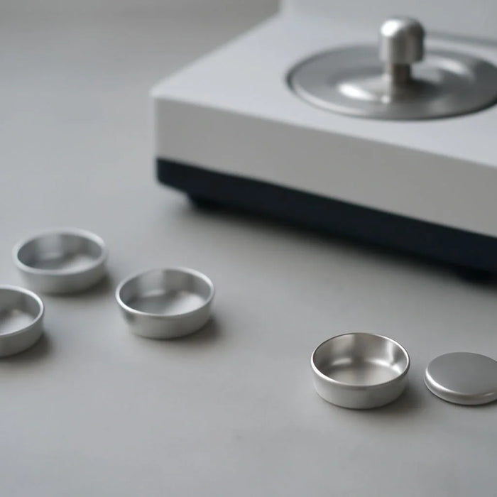 Image of TA Instruments DSC sample pan, suitable for various experimental applications.